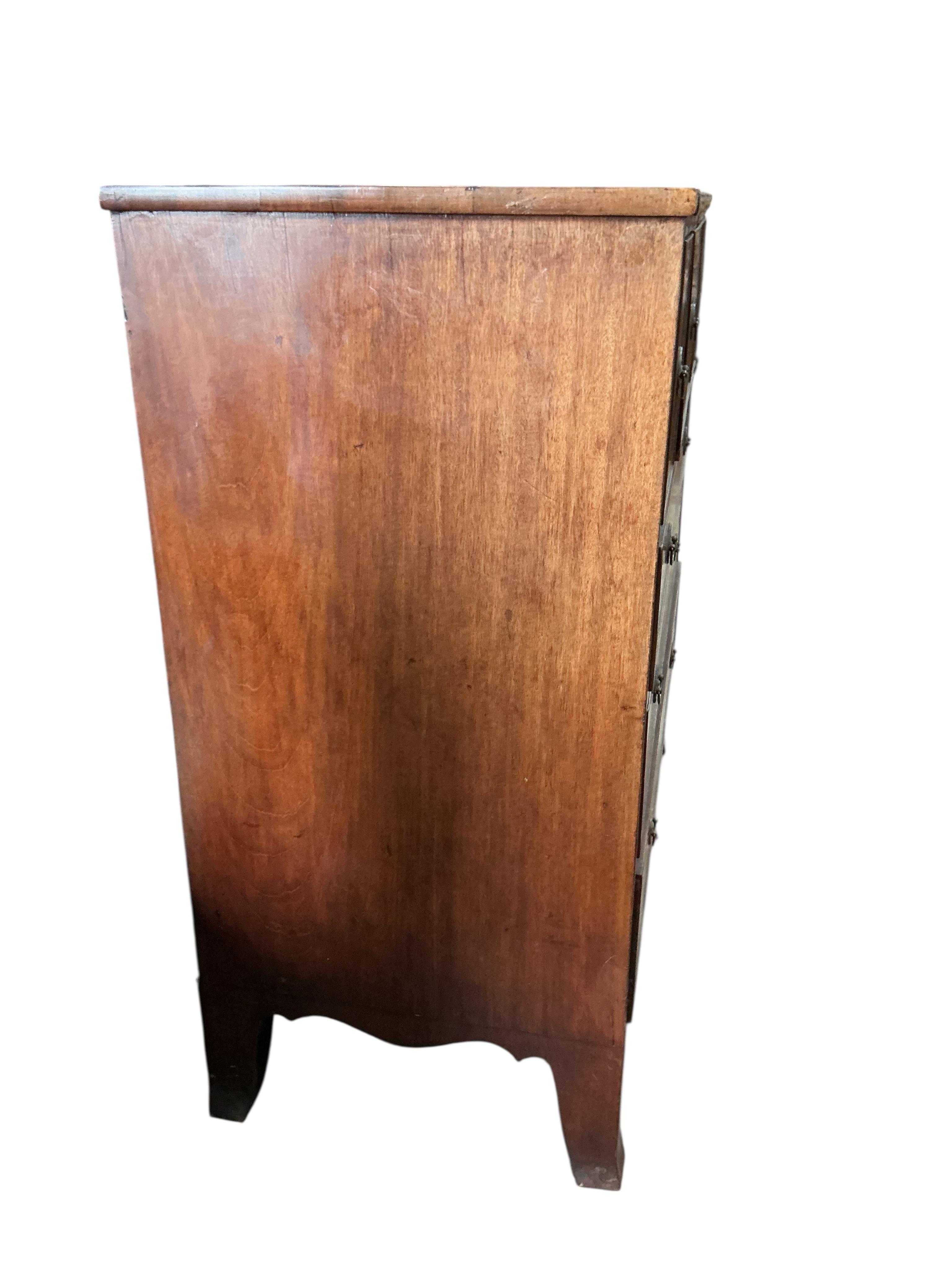 A George IV inlaid mahogany secretaire chest, width 124cm, depth 56cm, height 118cm